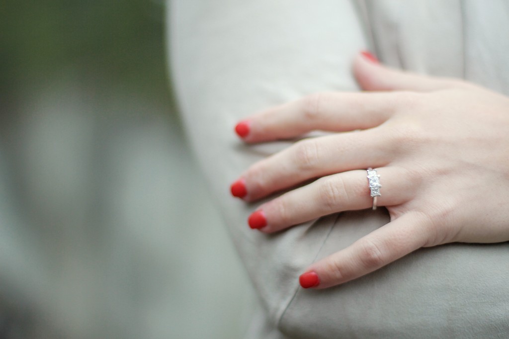 woman's engagement ring and red fingernails 