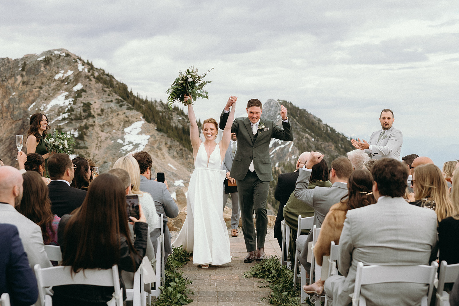 bride and groom celebrating during mountaintop ceremony in Golden, BC