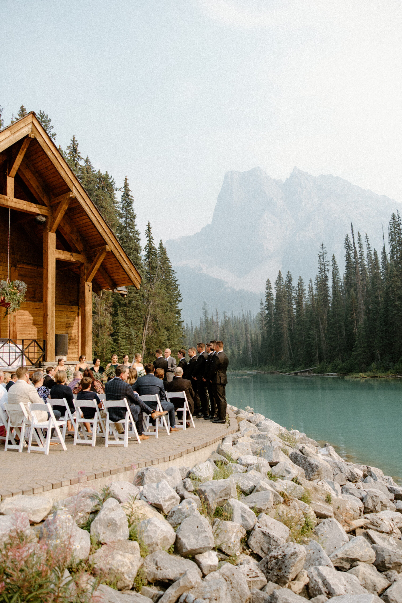ceremony by tree lined water and mountain views at Emerald Lake Lodge